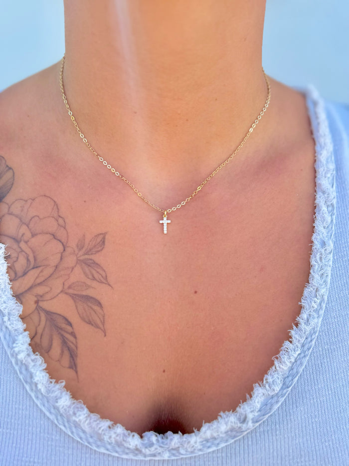 Adjustable 15–17.25 inch Amaris Gold Cross Necklace with gold-filled chain and sparkling cross charm being worn.