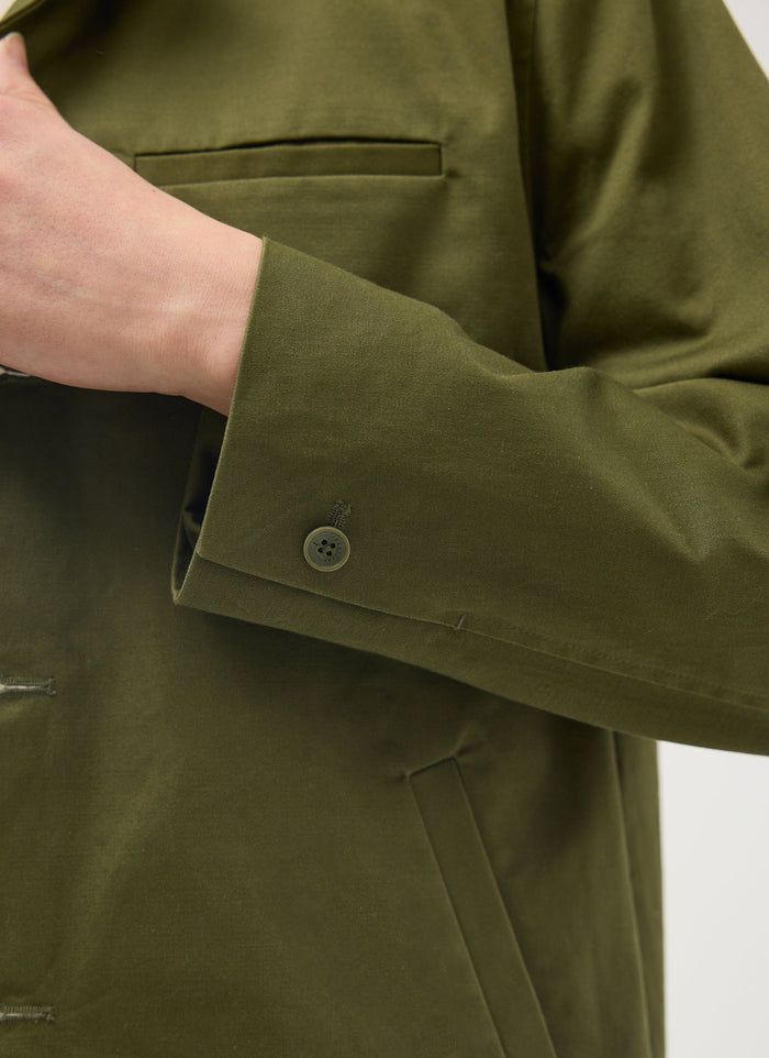 Close-up of the Percival Casual Workwear Jacket in khaki, detailing the cotton sleeve, branded button and jetted pocket.