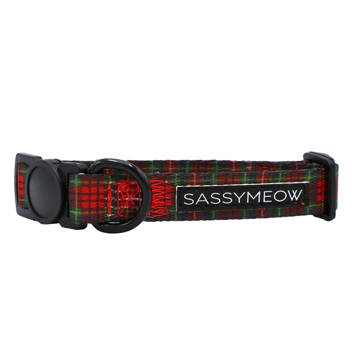 The Sassy Woof Cat Collar - Deck the Paws is a festive red and green plaid, adjustable collar with a black buckle and D-ring—perfect for the holidays. Features include a SASSYMEOW label for extra charm.