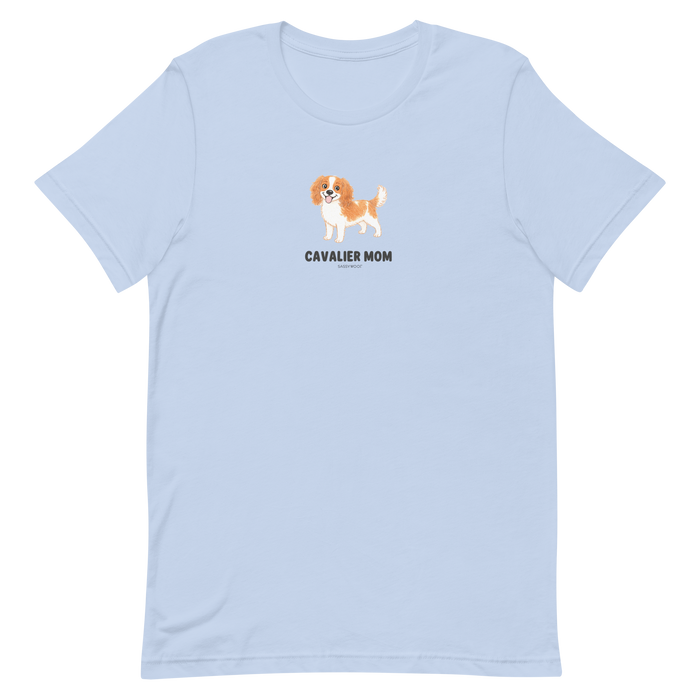 The Sassy Woof Cavalier Mom Tee is a light blue unisex dog shirt with a Cavalier King Charles Spaniel illustration above "CAVALIER MOM" in black—perfect for any proud Cavalier mom or breed lover.