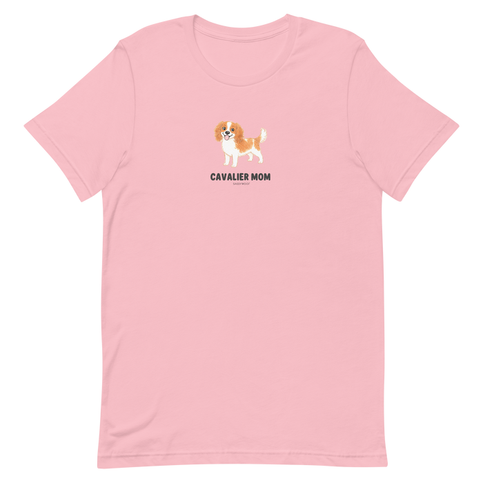 The Sassy Woof Cavalier Mom Tee is a light pink unisex shirt with a cute brown and white Cavalier King Charles Spaniel and bold "CAVALIER MOM" text—ideal for proud pup parents.