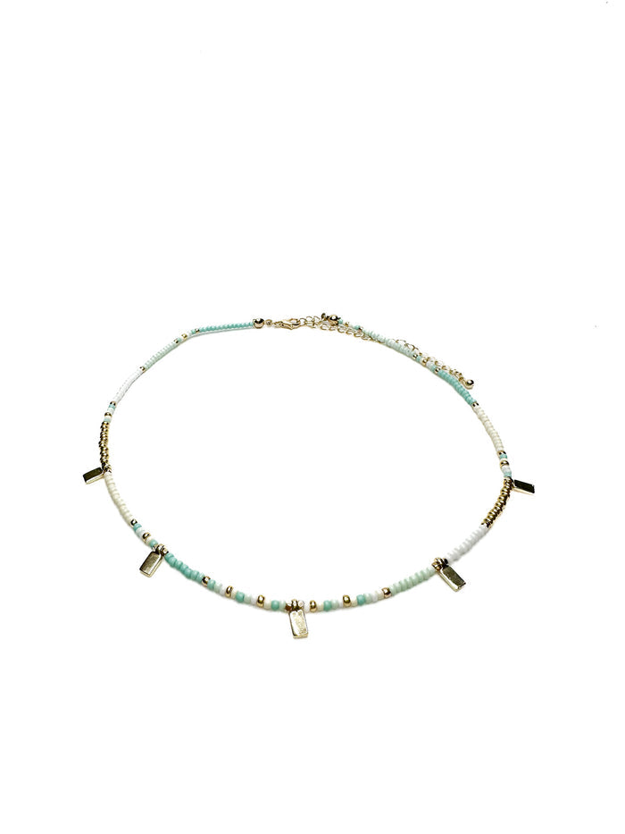 Necklace with small beads and petite gold accents on a white background