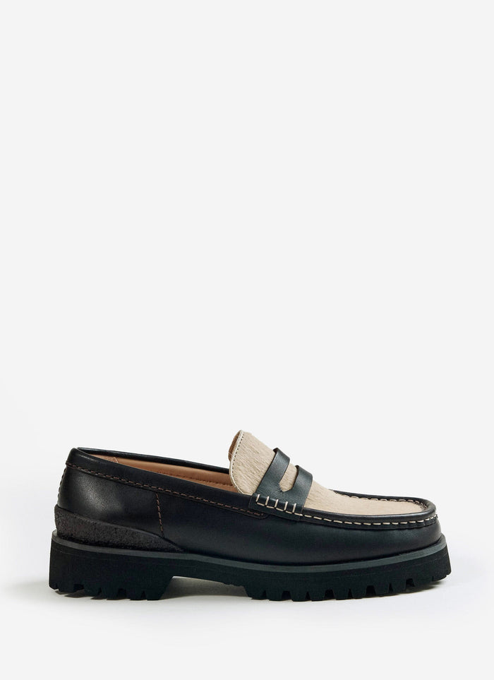A side profile of the Percival x Clarks Originals Yukoner Penny Loafer in brown leather, featuring a maple hair-on vamp.