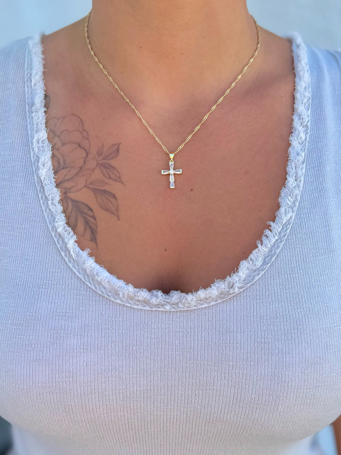 Cleo Crystal Cross Necklace from Ardor Boutique – 16.5-inch gold-filled chain with baguette-cut crystal cross pendant being worn.