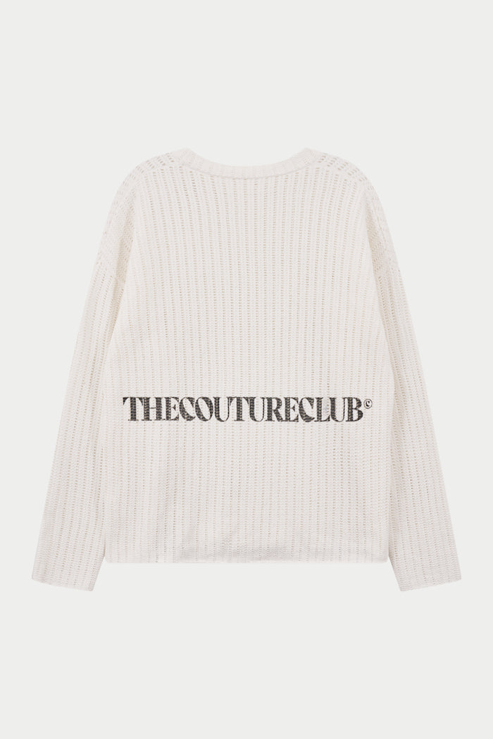 Crochet long sleeved white t-shirt with branding, against a white background.