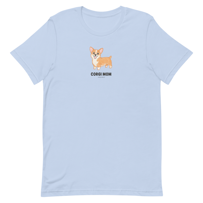 The Sassy Woof Corgi Mom Tee is a light blue t-shirt with a cute cartoon corgi above "CORGI MOM" in black on the chest—a perfect gift for any corgi lover.