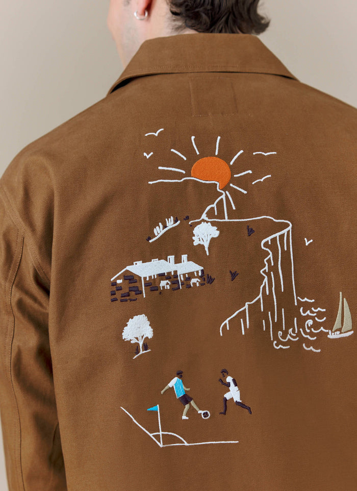 A close-up of the embroidered back of the brown Percival x Brighton & Hove Albion F.C. Canvas Workshirt.