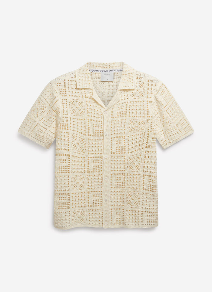 The Percival Crochet Groundsman Shirt in ecru, a short-sleeve cotton shirt with an intricate geometric crochet pattern.