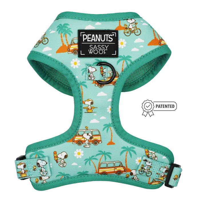 The Sassy Woof Dog Adjustable Harness - Peanuts™ Road Tripping features Snoopy and Woodstock on bikes and vans with palm trees and daisies. A patch reads "PEANUTS SASSY WOOF" with a patented icon—perfect for adventurous dogs.