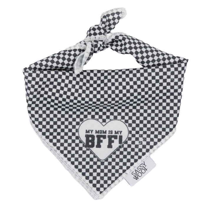 The Sassy Woof Dog Bandana - My Mom is my BFF features black and white checks, a heart, and playful text. It ties at the top, sports a Sassy Woof tag, and pairs perfectly with matching adjustable harnesses for a coordinated look.