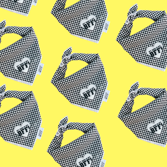Black and white checkered Sassy Woof Dog Bandana featuring a heart patch that reads “My Mom is my BFF,” displayed on a yellow background—perfect to pair with matching accessories or an adjustable dog harness.