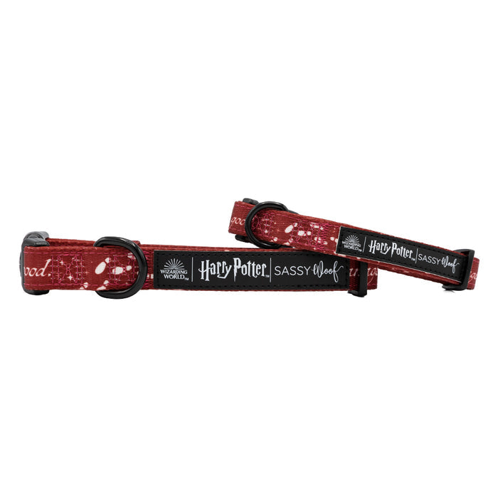 Two red adjustable Sassy Woof dog collars featuring a white Marauder's Map™ pattern from Harry Potter™, with black buckles, metal loops, and labels reading “Wizarding World,” “Harry Potter,” and “Sassy Woof.”.