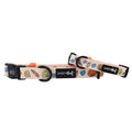 Two adjustable Sassy Woof "Shell Yeah" dog collars feature colorful seashell designs on a light background, black buckles, and neoprene material. Each collar includes a black Sassy Woof logo tag for added style and comfort.