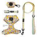 The Sassy Woof Dog Four Piece Bundle - Good Duck, Babe! features a pastel adjustable harness, collar, leash, and waste bag holder with duck and flower patterns—combining comfort and style for every puppy’s growth.