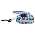 The Sassy Woof Dog Leash - Coastal Cuties features light blue seaside sailboats, colorful crabs, lobsters, seashells, and a black clasp. Pair with the matching harness for a perfect set.