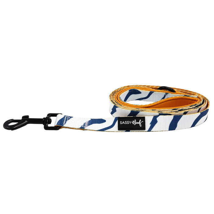 The Sassy Woof Dog Leash - STAR WARS™ Ahsoka features blue and white stripes, a black metal clasp, a Sassy Woof label, and an orange inner side inspired by Ahsoka.