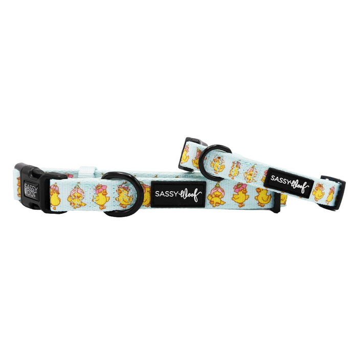 The Sassy Woof Dog Three Piece Bundle - Good Duck, Babe! features light blue collars with yellow cartoon ducks, pink flowers, black plastic buckles, and branded black labels—ideal for your puppy’s growth plan.