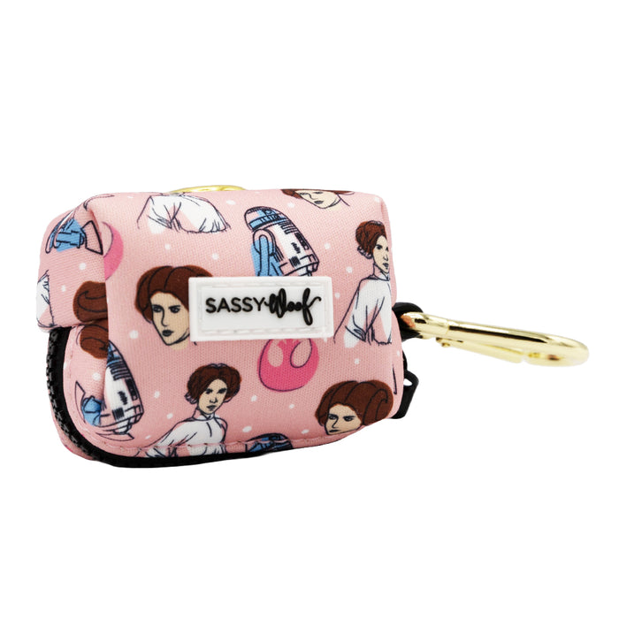 The Sassy Woof Dog Waste Bag Holder - STAR WARS™ Princess Leia is a small, pink holder with a gold clip featuring cartoon Leia, R2-D2, and Rebel symbols.