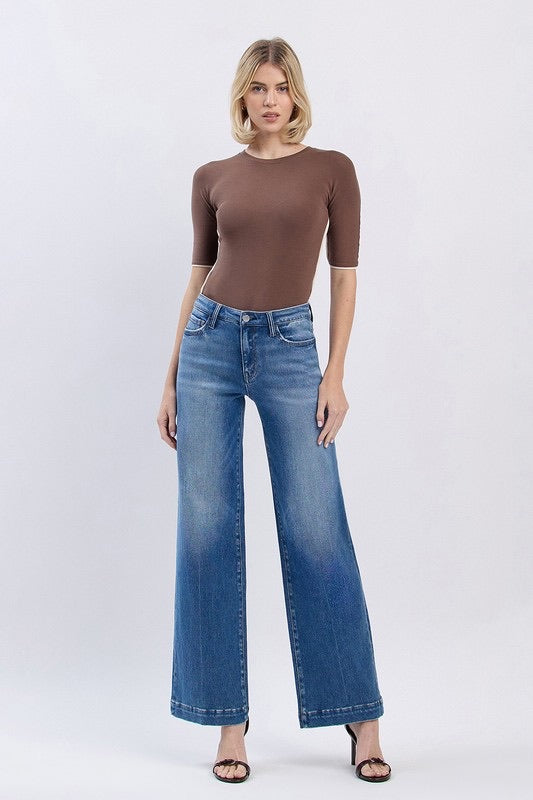 Model wearing high-rise wide leg Fallon jeans in medium wash denim, front view
