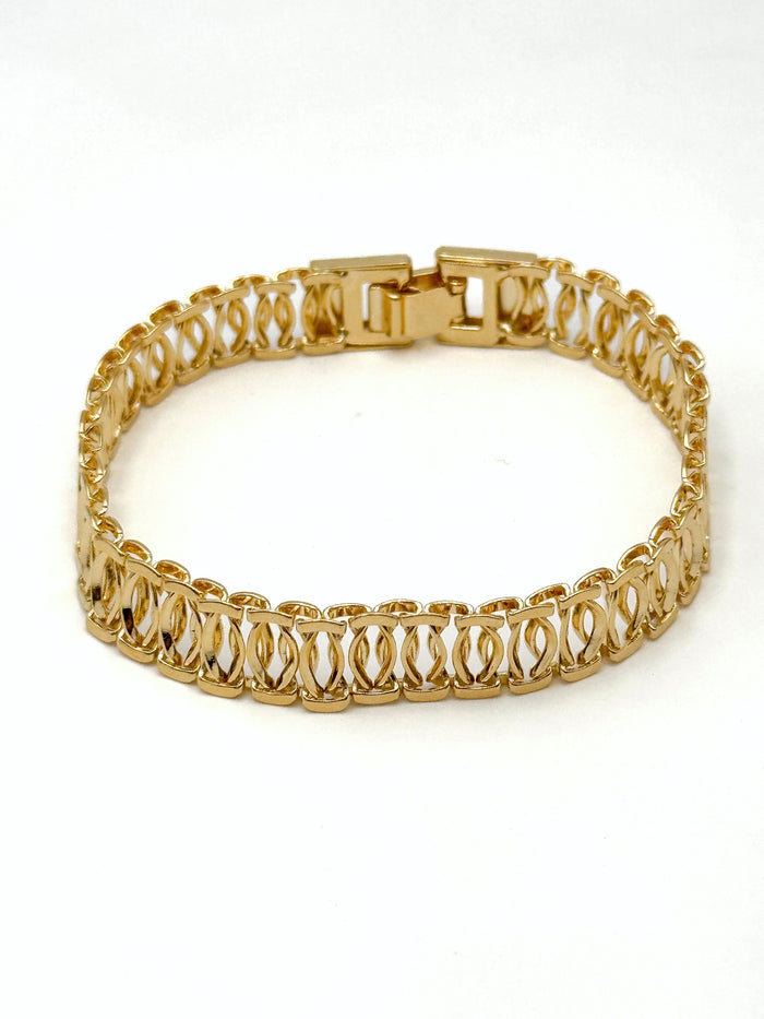 Gianna gold-tone openwork link bracelet with wide band and box clasp displayed on a white background