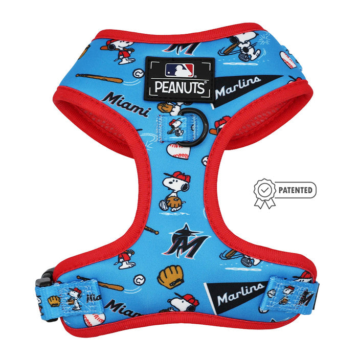 The Sassy Woof Harness Three Piece Bundle - MLB™ x Peanuts™ Miami Marlins™ is a blue adjustable dog harness with red trim, featuring Snoopy playing baseball and official MLB Peanuts Miami Marlins logos with a patented badge icon.