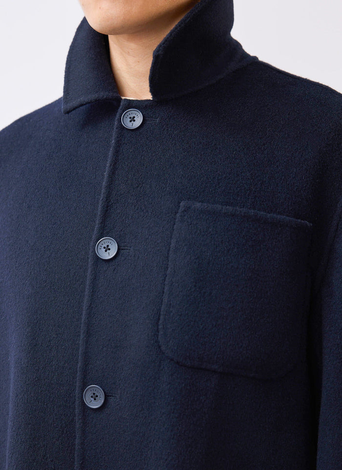 A close-up of the Percival Heavy Wool Overshirt in navy, showing the wool texture, patch pocket and branded buttons.