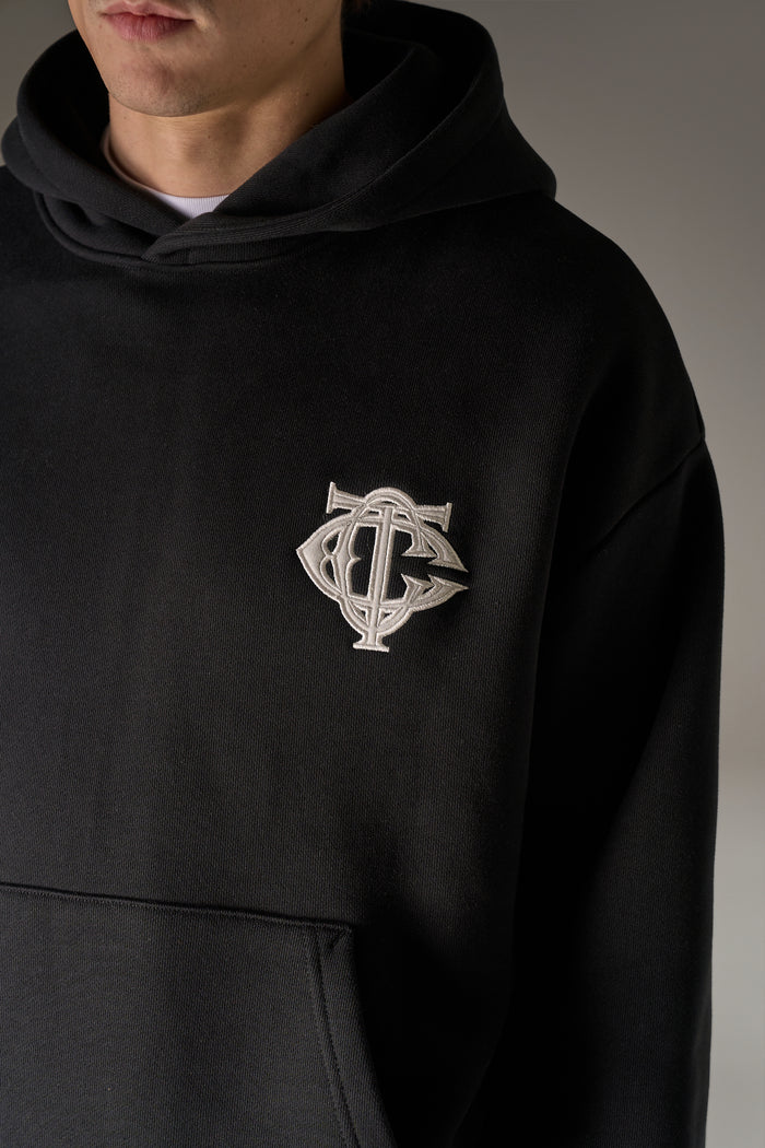 HEAVYWEIGHT MONOGRAM APPLIQUE EMBLEM HOODIE - BLACK
