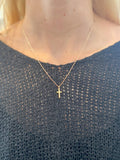 Juliette Cross Necklace in gold on delicate chain on woman's neck