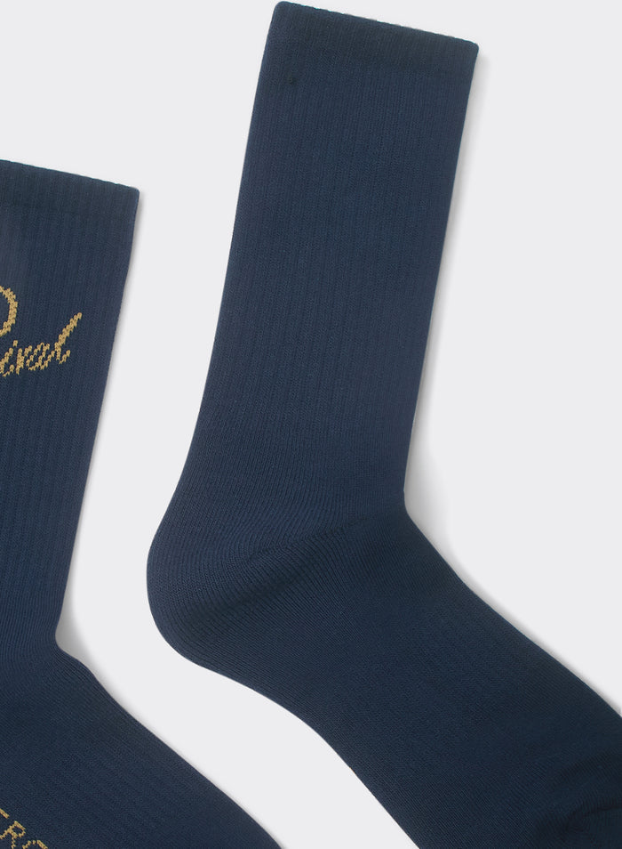 Navy Percival Kingsley Jacquard socks in a ribbed cotton-blend, featuring gold-tone script branding on a white background.