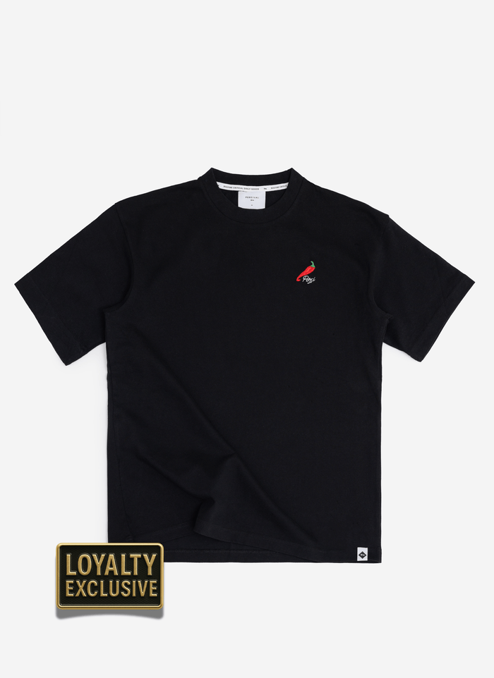 A flat lay of the black Percival Loyalty T Shirt, featuring the exclusive red chilli embroidery on the chest.