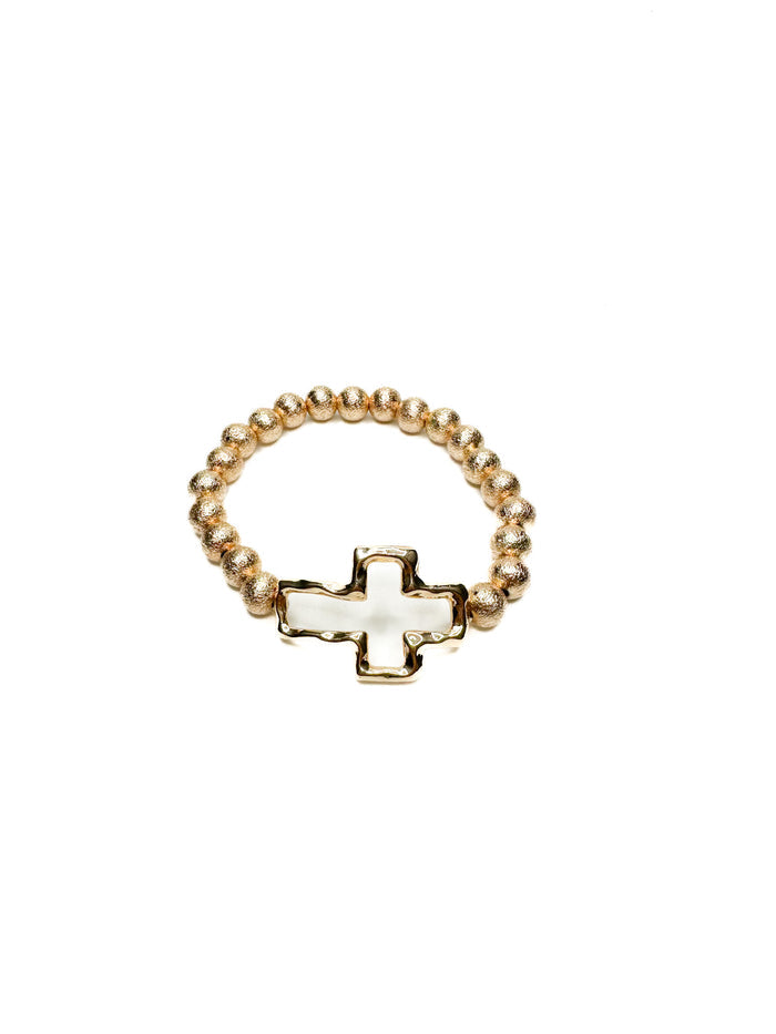 Gold beaded stretch bracelet with polished cross charm from Ardor Boutique