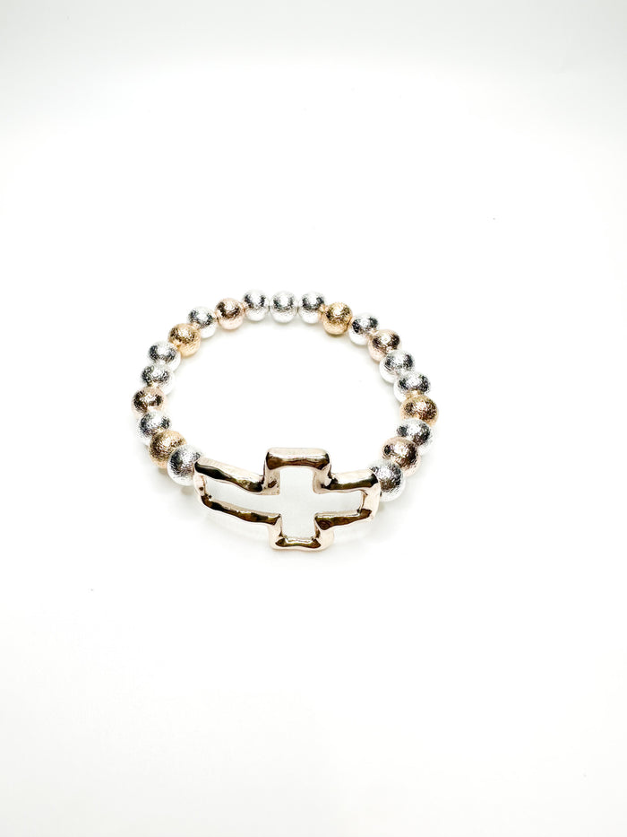 Silver and gold beaded stretch bracelet with polished cross charm from Ardor Boutique