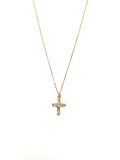 Gold cross necklace on a white background