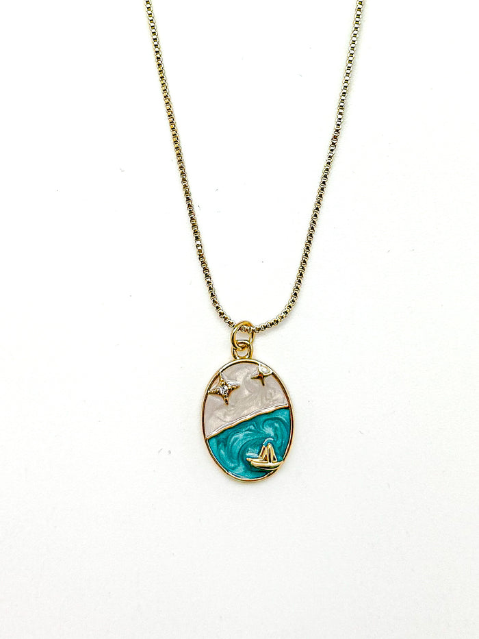 Marina Pendant Necklace with cubic zirconia star accents and golden sailboat on turquoise enamel wave.