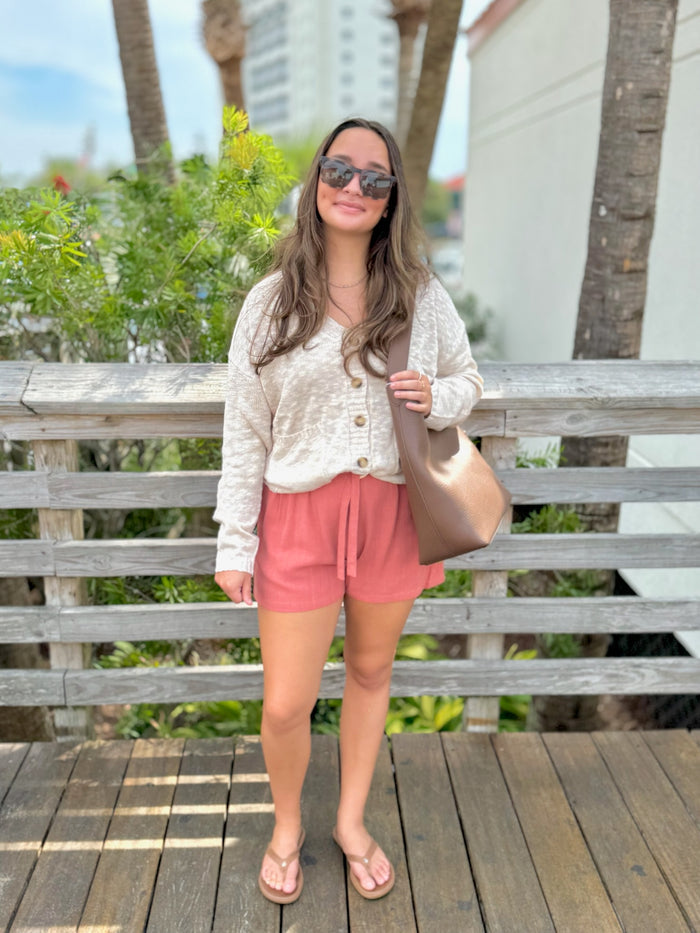 Melissa cardigan in beige being worn outside