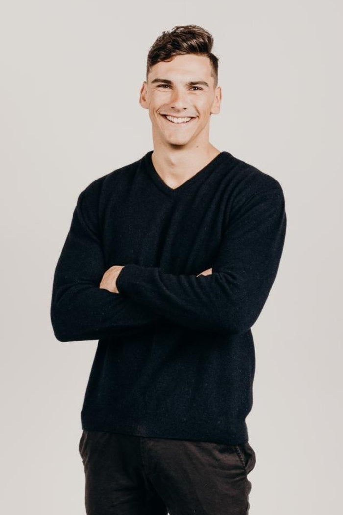 Man wearing a dark colour v-neck sweater