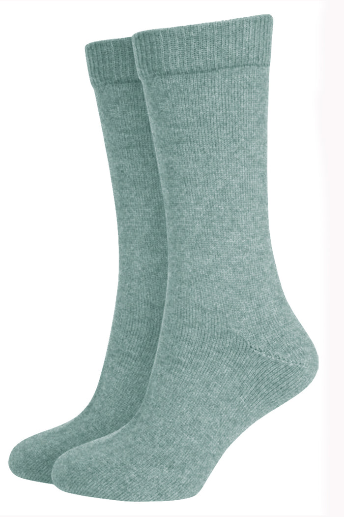 A pair of green Merinosilk plain socks, displaying the side profile of the socks with visible ribbed texture.