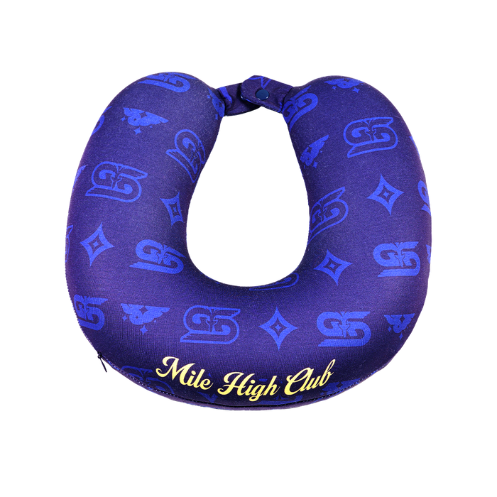 Close-up of a dark blue neck pillow with yellow "Mile High Club" text and subtle patterned design.