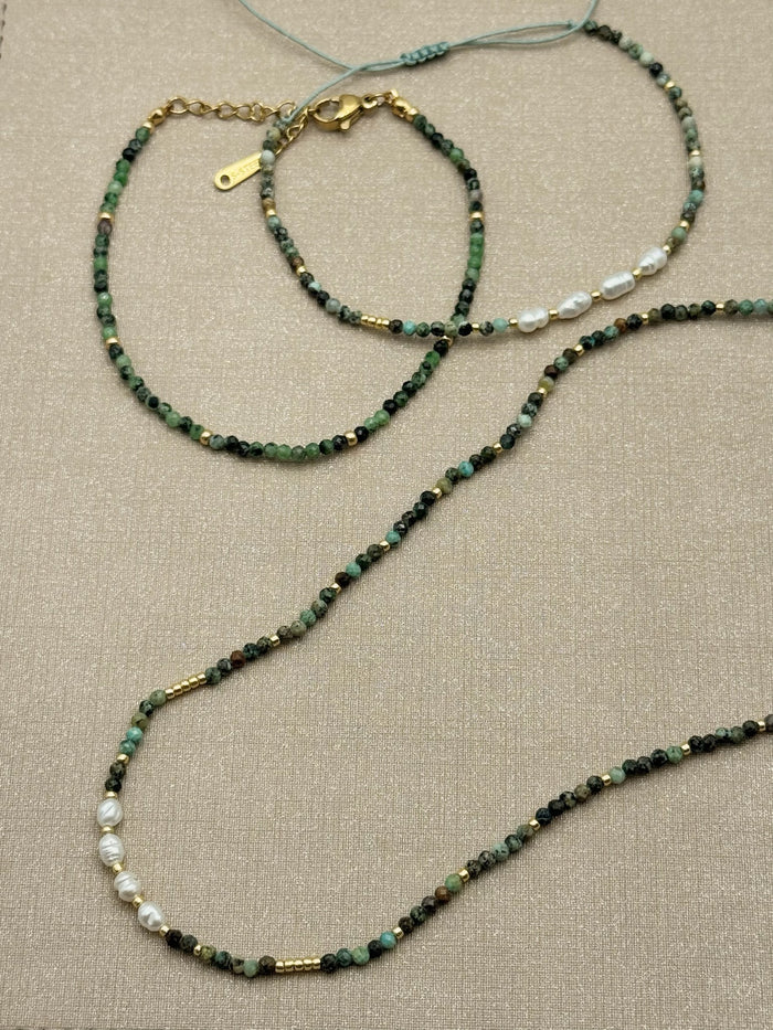 Flat lay of Nora Epidote Beaded Bracelet with Amina bracelet and Isla necklace