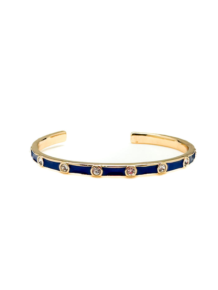 Gold and blue bracelet with gemstones on a white background