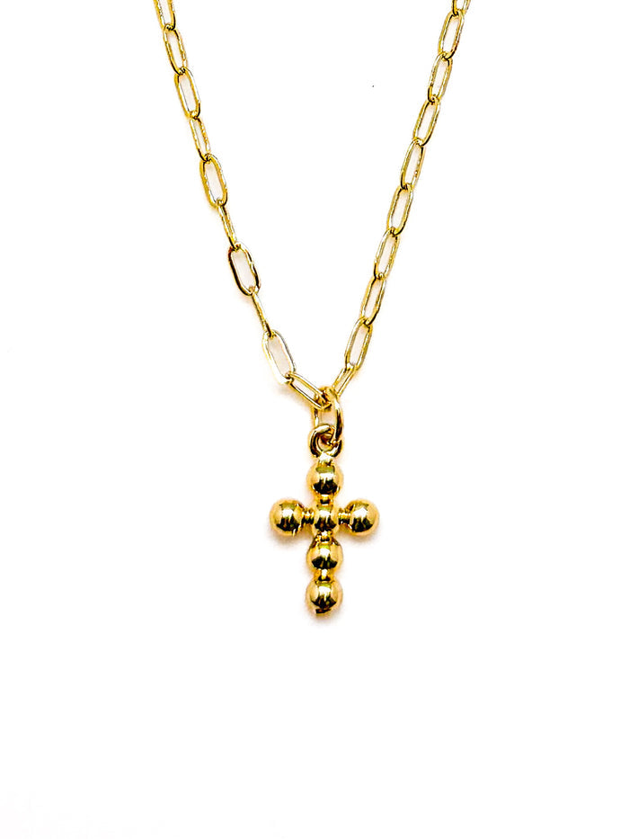 Gold necklace with a small cross pendant on a white background