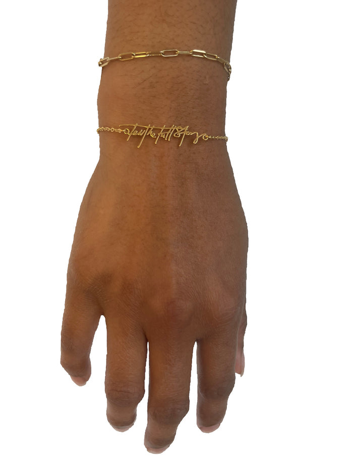 Gold bracelet shown worn on wrist, styled with another bracelet