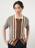 A model wears the Percival Teramo Knitted Polo Shirt in ecru and brown stripes against a white background.