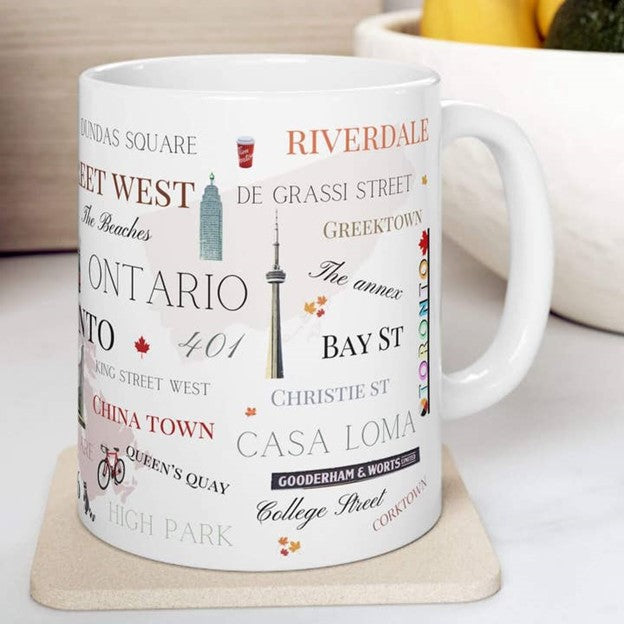 White mug with Toronto text and graphics on a coaster