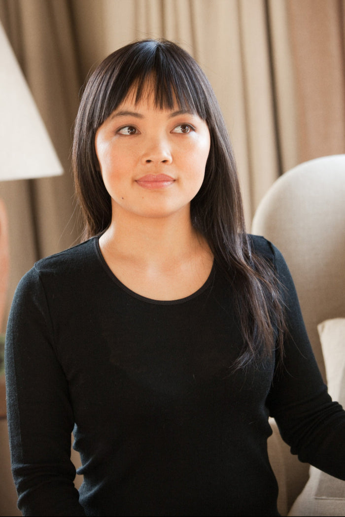 Women wearing a black merino thermal base layer top
