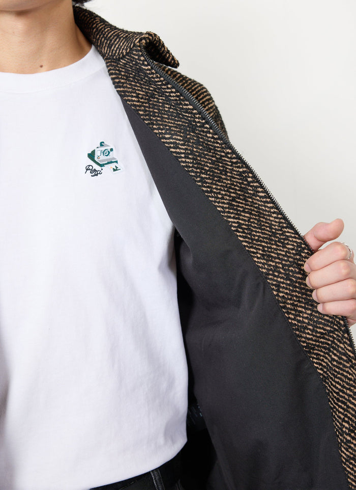 A close up of the Percival Zip Overshirt in Oak Twill, showing the textured fabric and black internal lining.